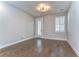 A spacious room with hardwood floors and an exit door at 3215 W De Leon St # 6, Tampa, FL 33609