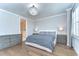 This primary bedroom features an elegant chandelier, hardwood floors, and a view into the ensuite bathroom at 3215 W De Leon St # 6, Tampa, FL 33609
