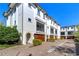Beautiful three-story townhomes with a brick driveway and landscaping at 3215 W De Leon St # 6, Tampa, FL 33609