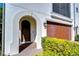 Elegant home featuring a dark wooden front door with stone archway and attached garage at 3215 W De Leon St # 6, Tampa, FL 33609