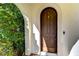Close-up of a wooden front door with arched frame, offering a warm and inviting entrance at 3215 W De Leon St # 6, Tampa, FL 33609