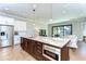 Open concept kitchen with an island that offers seating, stainless steel appliances, and adjacent living area at 3215 W De Leon St # 6, Tampa, FL 33609
