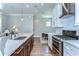 Modern kitchen featuring a large island, stainless steel appliances, and a stylish gas range at 3215 W De Leon St # 6, Tampa, FL 33609