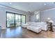 Bright living room featuring hardwood floors, a large white sofa and sliding glass doors to the balcony at 3215 W De Leon St # 6, Tampa, FL 33609