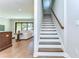 Elegant staircase with hardwood treads, white risers, and a wooden handrail at 3215 W De Leon St # 6, Tampa, FL 33609