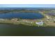 An aerial view of waterfront homes situated along a tranquil lake at 3319 Gulf City Rd, Ruskin, FL 33570