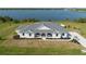 Aerial view of a beautiful home with a large yard, close to a serene lake at 3319 Gulf City Rd, Ruskin, FL 33570