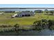 Backyard view of a waterfront home with lush landscaping and dock access at 3319 Gulf City Rd, Ruskin, FL 33570