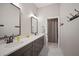 Bathroom featuring double sinks, vanity with drawers, and large mirrors at 3319 Gulf City Rd, Ruskin, FL 33570