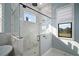 Glass enclosed shower with marble and a window to the backyard at 3319 Gulf City Rd, Ruskin, FL 33570