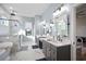 Bathroom featuring a freestanding tub, glass-enclosed shower, and vanity with dual sinks at 3319 Gulf City Rd, Ruskin, FL 33570