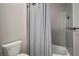 Bathroom with a shower and tub combo, gray tile and a gray shower curtain at 3319 Gulf City Rd, Ruskin, FL 33570