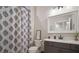 Bathroom featuring a patterned shower curtain and a custom framed mirror at 3319 Gulf City Rd, Ruskin, FL 33570
