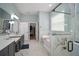 Bathroom features a freestanding tub, glass-enclosed shower, and vanity with sink at 3319 Gulf City Rd, Ruskin, FL 33570