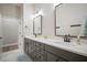 Elegant bathroom with double sinks, granite countertops, and wood cabinets at 3319 Gulf City Rd, Ruskin, FL 33570