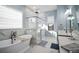 Relaxing bathroom with freestanding tub, glass-enclosed shower, and dual sink vanity at 3319 Gulf City Rd, Ruskin, FL 33570