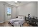 Cozy bedroom featuring a bed, desk, and large window providing natural light and exterior views at 3319 Gulf City Rd, Ruskin, FL 33570