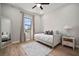 Bright bedroom with a large window, daybed with throw pillows, and a decorative full-length mirror at 3319 Gulf City Rd, Ruskin, FL 33570