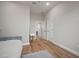 Bright bedroom with wood flooring, a vanity table, and several doors leading to other rooms at 3319 Gulf City Rd, Ruskin, FL 33570