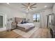 Spacious bedroom featuring a tufted headboard, ceiling fan, and natural light from the window at 3319 Gulf City Rd, Ruskin, FL 33570