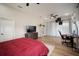 Bright bedroom with a ceiling fan, wood floors, and modern furniture including TV and desk at 3319 Gulf City Rd, Ruskin, FL 33570