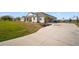 Spacious home with a long driveway, attached garage, and landscaped front yard near the water at 3319 Gulf City Rd, Ruskin, FL 33570