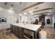 Open-concept kitchen with hardwood floors, white countertop island, modern appliances, and wood beam accents at 3319 Gulf City Rd, Ruskin, FL 33570