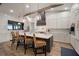 Beautiful kitchen features white countertops, stainless steel appliances, modern range hood, and wood beam accents at 3319 Gulf City Rd, Ruskin, FL 33570