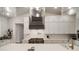 Bright kitchen boasts white countertops, stainless steel appliances, a modern range hood, and modern countertops at 3319 Gulf City Rd, Ruskin, FL 33570
