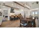 Open kitchen and dining area featuring a large island, wood floors, and modern lighting fixtures at 3319 Gulf City Rd, Ruskin, FL 33570