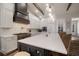Bright kitchen features white countertops, stainless steel appliances, an island, and wood beam accents at 3319 Gulf City Rd, Ruskin, FL 33570