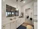 Bright kitchen features white cabinetry, subway tile backsplash, and a large window overlooking a waterfront view at 3319 Gulf City Rd, Ruskin, FL 33570