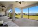 The lanai features large windows that provide expansive views of the lush green yard and waterway at 3319 Gulf City Rd, Ruskin, FL 33570
