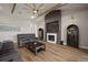 Comfortable living room featuring a fireplace with built-ins, a ceiling fan, and hardwood floors at 3319 Gulf City Rd, Ruskin, FL 33570