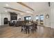 Open-concept living room with fireplace, ceiling fan, wood beams, large windows, and hardwood flooring at 3319 Gulf City Rd, Ruskin, FL 33570