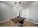 Bright home office featuring hardwood floors, a modern desk, and neutral gray wall paint at 3319 Gulf City Rd, Ruskin, FL 33570