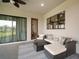 Cozy outdoor patio with wicker furniture, a modern coffee table, and sliding glass doors at 3319 Gulf City Rd, Ruskin, FL 33570