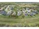 Scenic aerial view of a quiet neighborhood with green lawns, lush trees and lovely homes at 34714 Heavenly Ln, Dade City, FL 33525