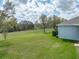 Expansive backyard with verdant lawn and mature trees, providing privacy and natural beauty at 34714 Heavenly Ln, Dade City, FL 33525