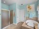 Bright bathroom featuring a soaking tub, walk-in shower and tile flooring at 34714 Heavenly Ln, Dade City, FL 33525