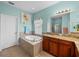 Bathroom featuring a garden tub, wood cabinets with granite countertops, and a separate shower at 34714 Heavenly Ln, Dade City, FL 33525