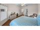 Bedroom with a TV, hardwood floors, blue patterned comforter, and ensuite bathroom at 34714 Heavenly Ln, Dade City, FL 33525