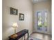 Inviting foyer with decorative console table, tiled floor and glass front door at 34714 Heavenly Ln, Dade City, FL 33525