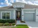 A charming home entrance showcasing a well-manicured lawn and a cozy atmosphere at 34714 Heavenly Ln, Dade City, FL 33525
