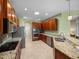 Spacious kitchen with stainless steel appliances, wood cabinets, and granite countertops at 34714 Heavenly Ln, Dade City, FL 33525