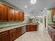 Well-lit kitchen featuring wood cabinetry, granite counters, stainless steel appliances, and an open layout at 34714 Heavenly Ln, Dade City, FL 33525