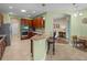 Eat-in kitchen with wooden cabinets, granite counters and access to living room at 34714 Heavenly Ln, Dade City, FL 33525