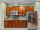 Kitchen with stainless steel appliances, wood cabinetry, and granite countertops at 34714 Heavenly Ln, Dade City, FL 33525