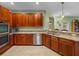 Stylish kitchen features stainless appliances, granite counters, and wooden cabinetry at 34714 Heavenly Ln, Dade City, FL 33525
