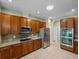 Kitchen features stainless appliances, wood cabinets, mosaic backsplash, and granite countertops at 34714 Heavenly Ln, Dade City, FL 33525